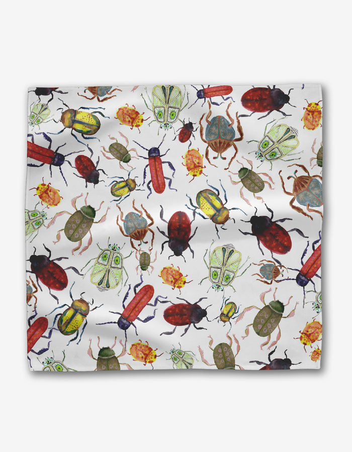 The African Beetles dinner napkins by Taryn Brennan feature a vibrant, multicolored pattern of whimsical illustrated insects on white Geosuede fabric made from recycled materials.