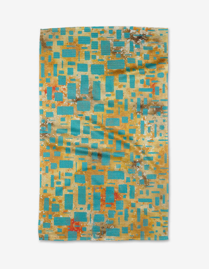 African Blue Geometry by Taryn Brennan is a rectangular, eco-friendly towel with turquoise, yellow, and orange geometric patterns—ideal as a reusable kitchen or tea towel.