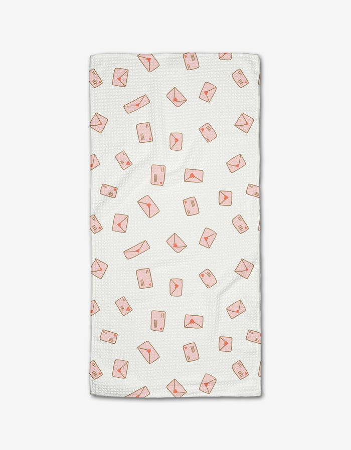 The Amatus Bar Towel by Amy MacCready features white textured Geoweave fabric with a scattered pink envelope and mail parcel pattern. Ultra-absorbent and stylish, its perfect for everyday use. Displayed on a plain white background.