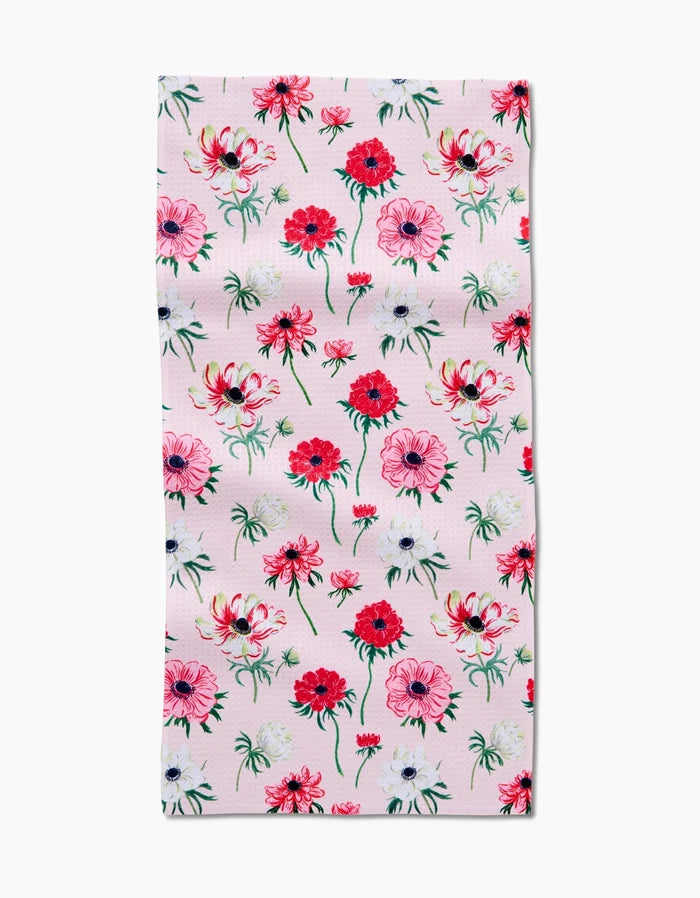The Anemone Garden Flowers Bar Towel by Linda Fox features a pale pink background with a repeating pattern of red, pink, and white flowers with green stems and leaves, evenly spread across recycled fabric.