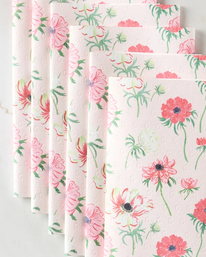 Stacked sheets of Anemone Garden Flowers by Linda Fox, featuring textured white paper with pink floral patterns and green stems, made from eco-friendly paper towels for a sustainable, stylish touch.
