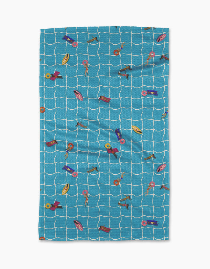 The Geometry At The Pool beach towel features a blue and white grid design with colorful poolside illustrations, made from ultra-absorbent Geoweave fabric for quick drying and comfort.
