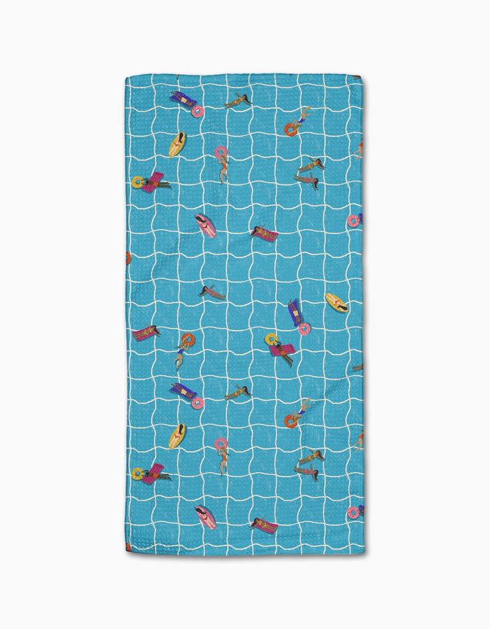 The At The Pool beach towel by Geometry features a rectangular blue Geoweave fabric with a white grid and colorful illustrations of people swimming and relaxing on pool floats.