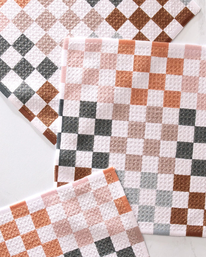 The Autumn Checkers set by GEOMETRY features three recycled dishcloths with a brown, gray, and white checkerboard pattern—stylish and eco-friendly for modern kitchens.