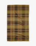 The Autumn Plaid mat by Danelys Sidron features a tan base with black, brown, and red plaid, crafted from recycled materials and shown flat on a white surface.