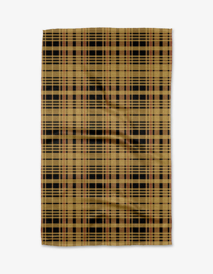 The Autumn Plaid mat by Danelys Sidron features a tan base with black, brown, and red plaid, crafted from recycled materials and shown flat on a white surface.