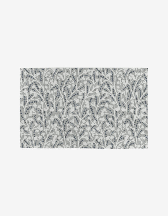 The Babys Breath rug by Katie OShea is a rectangular, reusable option with a repeating pattern of white flowers and leaves with light blue accents on gray—an eco-friendly alternative to paper towels.