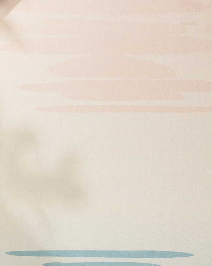 Minimalist background with soft beige, light pink cloud-like shapes, and blue accents at the bottom. Leaf shadow on the left—perfect for showcasing your GEOMETRY Balance non-slip or recycled yoga towel.
