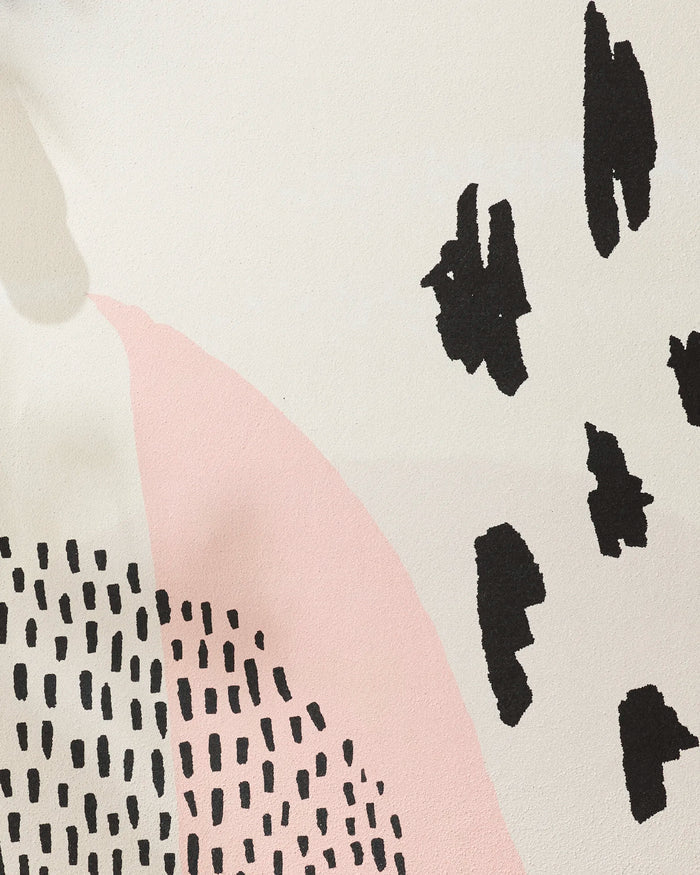 The "Bare" artwork by GEOMETRY showcases abstract design on a cream background, featuring a large pink curved shape reminiscent of a yoga towel, scattered black dashes, and clusters of irregular solid black shapes on the right.
