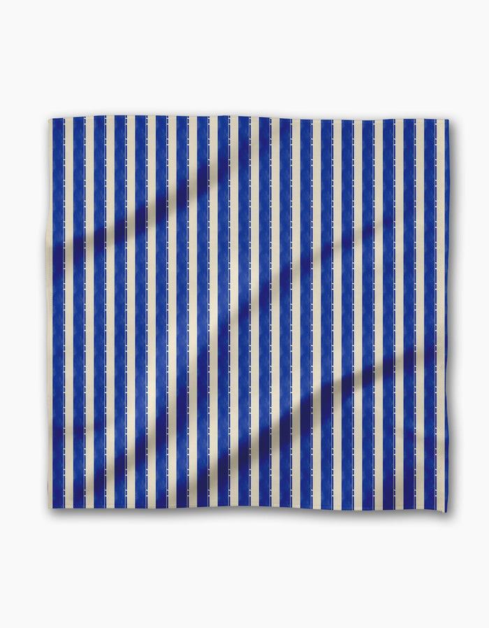 Geometry’s Bauhaus Stripe features vertical blue and white stripes on geosuede fabric with a subtle textured pattern—a chic choice for stylish dinner napkins.
