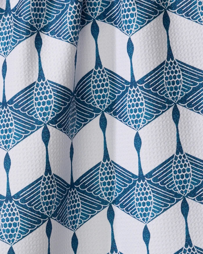 BB Cubed by Renee Fly features a blue geometric pattern, resembling stylized long-necked birds, printed on white textured fabric. Its repetitive interlocking design makes it a modern kitchen accent, ideal as a tea towel.