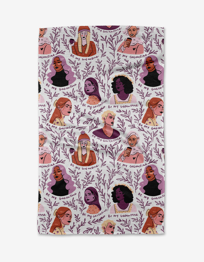 The Be My Galentine cloth face covering by Janna Sue Design is made from recycled materials and features diverse illustrated women among purple leafy branches with playful “Be My Galentine” text on a white background.