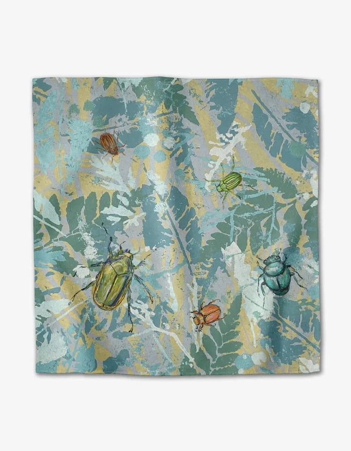 The Beetles square scarf by Taryn Brennan features a leafy blue and green background with colorful beetle illustrations printed on soft Geosuede fabric.