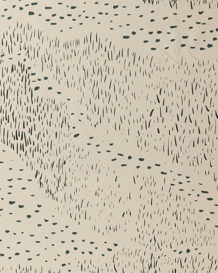 The Bend yoga towel by GEOMETRY features an abstract pattern of black dashes and dots on beige, offering a stylish, organic look inspired by rainfall—combining unique design with non-slip functionality.