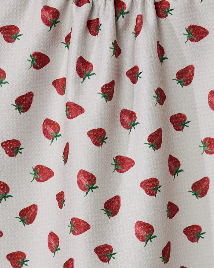 The Berry Patch tea towel by Geometry features a textured white fabric with a repeating red strawberry pattern and green stems. Ultra-absorbent and made from recycled materials, it’s perfect for your kitchen.