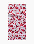 The Best Friends rectangular bar towel by Charlie Rowan Designs features a repeating red and pink pattern of hearts, cassette tapes, radios, headphones, soda bottles, and envelopes on white. Ultra-absorbent—fun and functional!.
