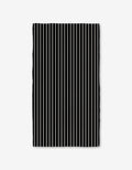 The GEOMETRY Black Linen Bath Towel features evenly spaced vertical black and white stripes on a plain white background, with slightly wavy edges that highlight its ultra-absorbent Geoweave technology.