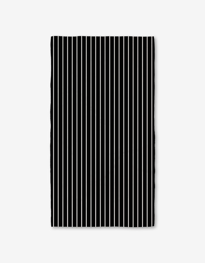 The GEOMETRY Black Linen Bath Towel features evenly spaced vertical black and white stripes on a plain white background, with slightly wavy edges that highlight its ultra-absorbent Geoweave technology.