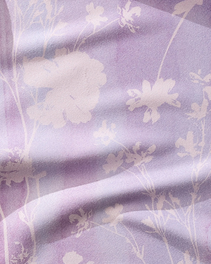 The GEOMETRY Bloom Blend features light purple fabric with a soft watercolor look and delicate white florals. Its ultra-absorbent, lightly wrinkled texture adds gentle shadows—ideal as a quick-drying fitness towel.