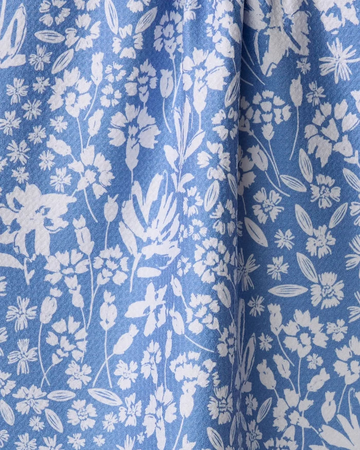 The Bloom Me Over Floral recycled kitchen towel by Hufton Studio features a densely arranged white floral print on blue fabric, adding eco-friendly charm and style to your space.