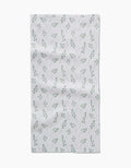 The Linda Fox Blue Bells Green Bar Towel features a Geoweave fabric with a subtle pattern of small green leaves and branches, evenly spaced on a white background, and a slight wrinkled texture for added charm.