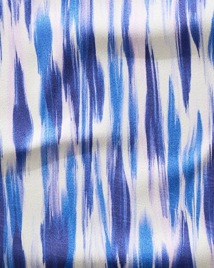The GEOMETRY Blue Blast fitness towel features a wavy blue and white abstract design on textured fabric—ultra-absorbent, made from recycled materials.