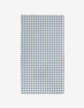 The Aubrey Fairchild Blue Gingham Luxe Bath Towel features a blue and white check pattern and ultra-absorbent Geoweave technology, shown flat on a white background.