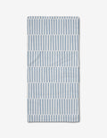 The Blue Stripes Bar Towel by Aubrey Fairchild features vertical blue and white stripes in horizontal bands on a white background, crafted from Geoweave fabric and neatly folded on a white surface.