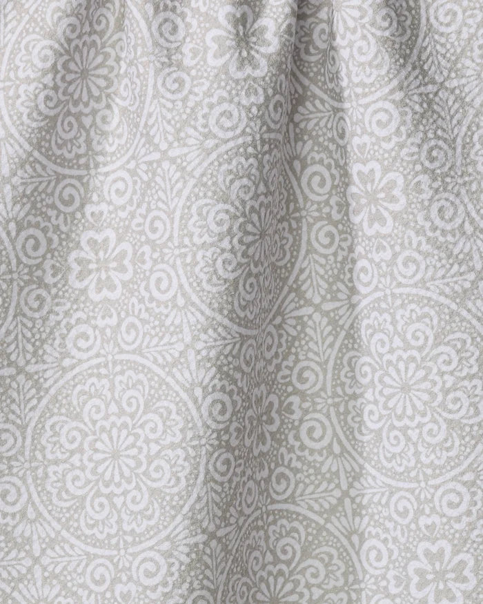Close-up of the Kris Ruff Boho Medallion dish towel, crafted from absorbent light gray fabric and adorned with a detailed white floral and geometric mandala pattern. Soft texture and gentle folds add subtle shadows to the surface.
