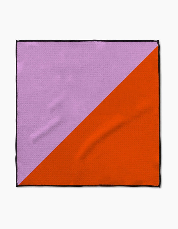 The Geometry Bold Horizon Paw Towel features a diagonal color split—light purple in the upper left, bright orange in the lower right—with a slim black border, crafted from ultra-absorbent Geoweave fabric for optimal drying.