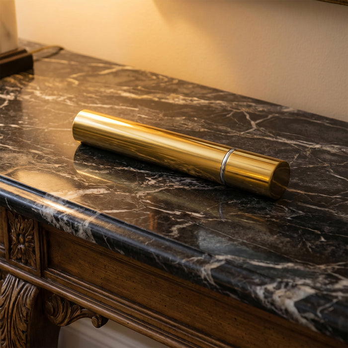 Bronze scattering tube on a dark marble surface