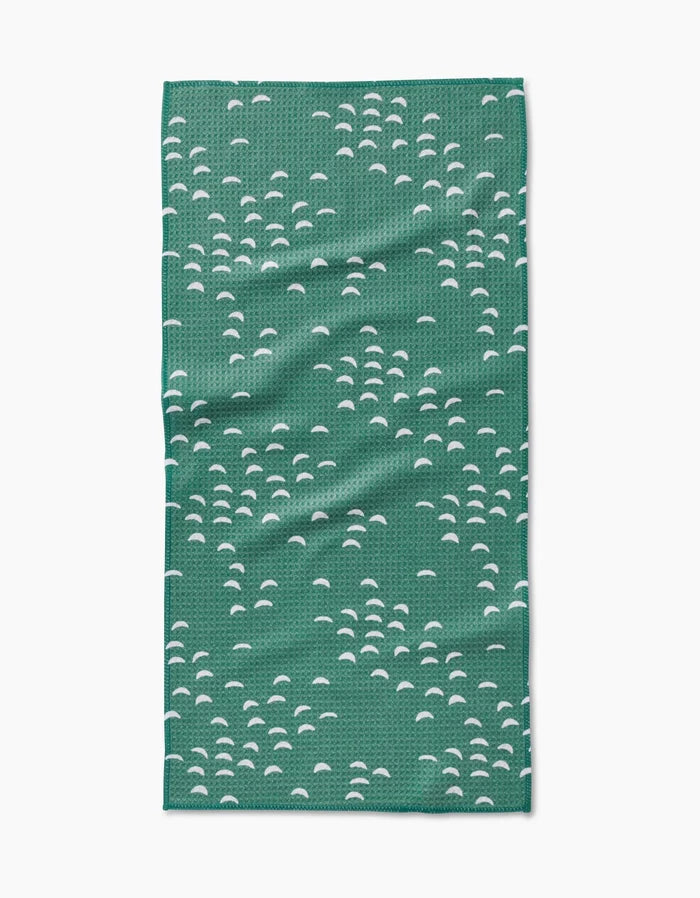 The Breezeway by Jessica Swift is a green rectangular Geoweave cloth featuring clusters of small white half-circle patterns across its surface.