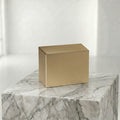Bronze urn insert on a marble surface with a white background