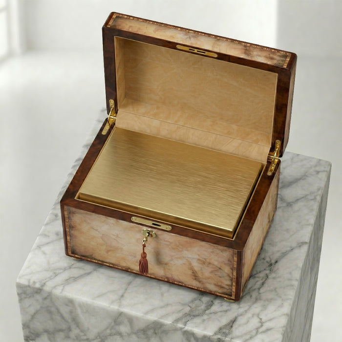 Wooden urn chest with a bronze insert and lid open on a marble surface