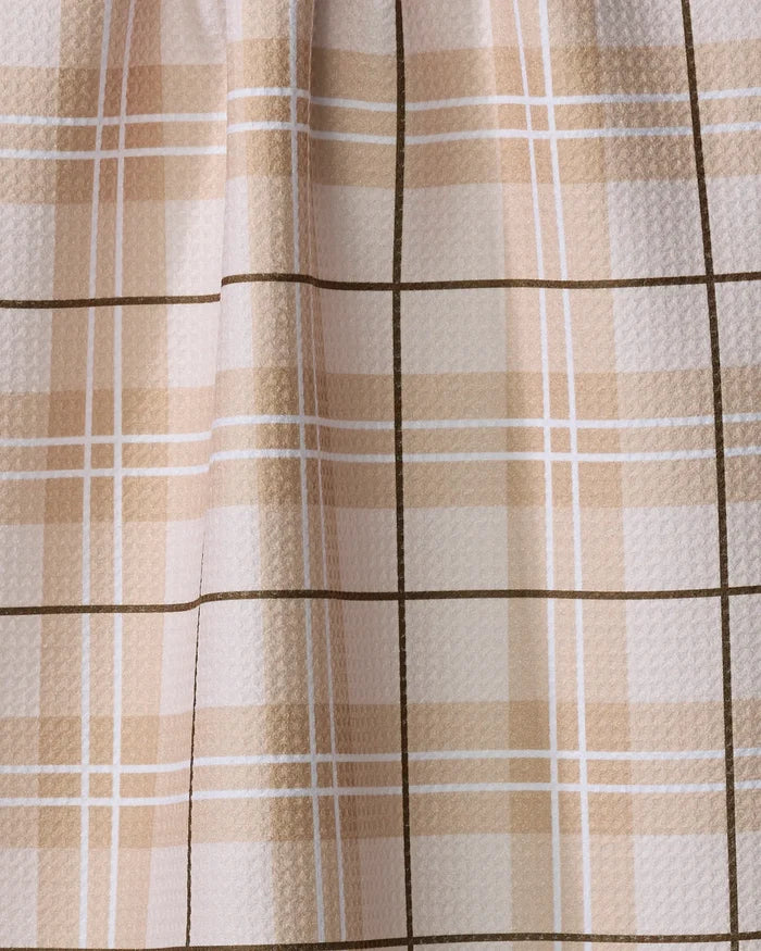 Close-up of the Purely Kaylie Brown Sugar recycled kitchen towel, featuring a beige and cream plaid pattern with intersecting lines; its ultra-absorbent, softly draped material is slightly textured.