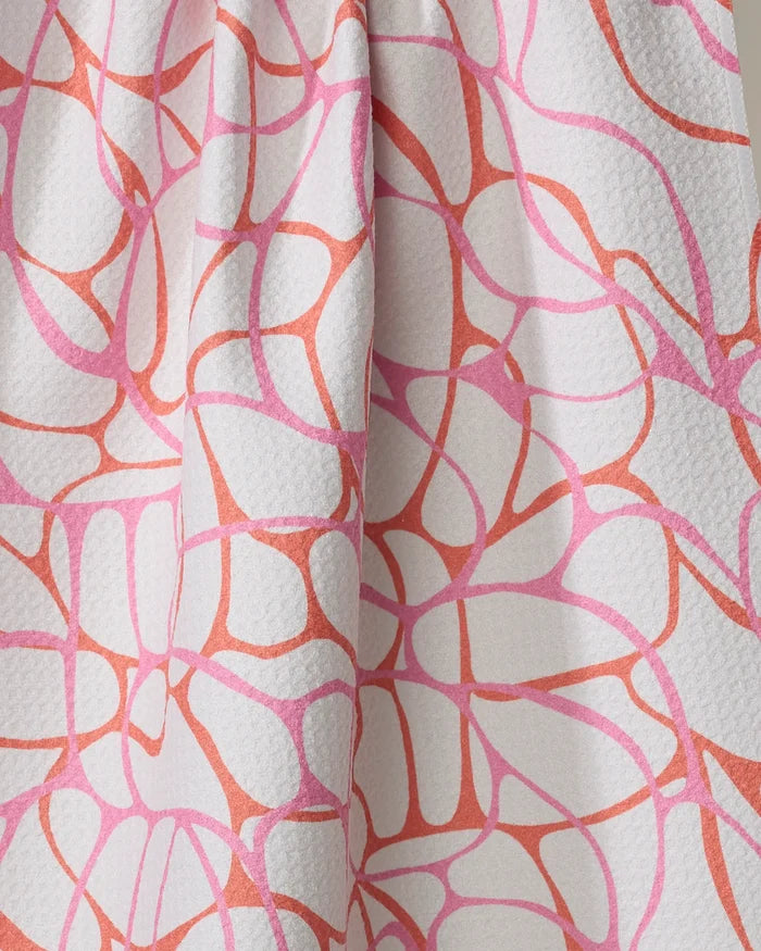 Close-up of the Rachel Parker "Bubble Abstract" tea towel, made from recycled materials with a white textured fabric and organic, web-like pink and coral abstract lines. Ultra-absorbent and eco-friendly design.