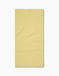 A neatly laid flat, Butter Yellow rectangular Bar Towel from GEOMETRY with a subtle textured Geoweave pattern, photographed on a plain white background.