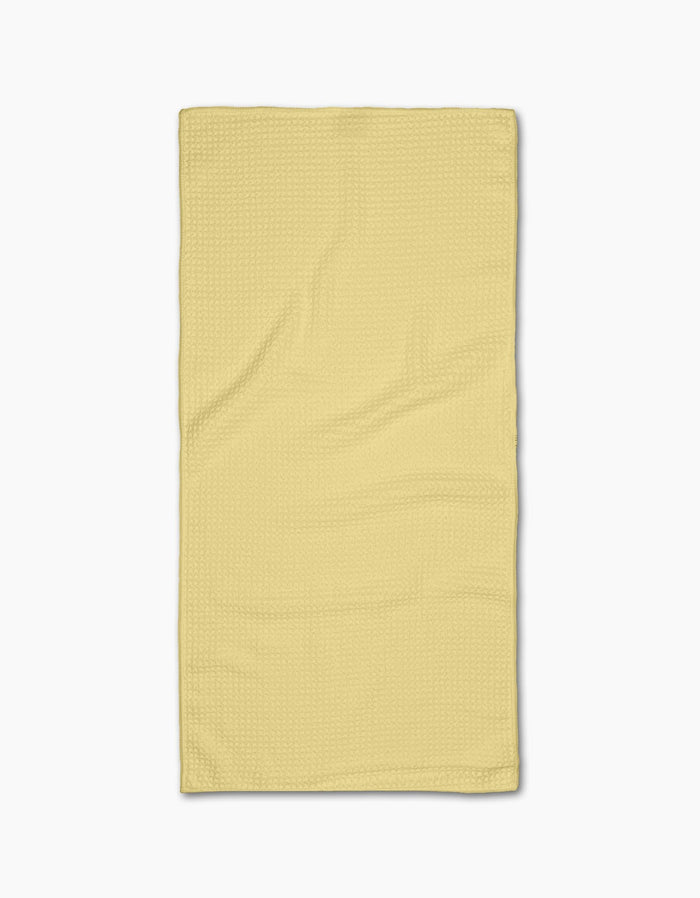 A neatly laid flat, Butter Yellow rectangular Bar Towel from GEOMETRY with a subtle textured Geoweave pattern, photographed on a plain white background.