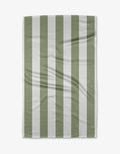 The Candy Mint tea towel by Kailee Wright is rectangular with vertical sage green and white stripes. Displayed flat, its quick-drying fabric shows a subtle textured pattern and slight creases against a white background.