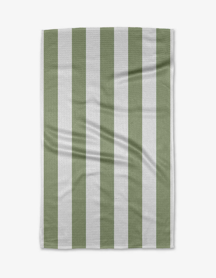 The Candy Mint tea towel by Kailee Wright is rectangular with vertical sage green and white stripes. Displayed flat, its quick-drying fabric shows a subtle textured pattern and slight creases against a white background.