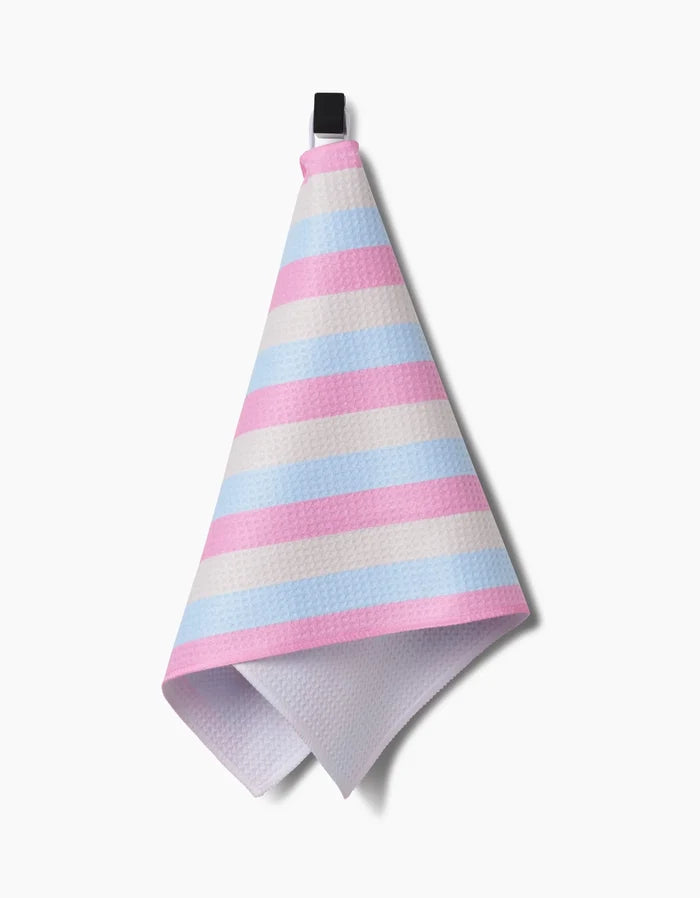 The Amy Droubay Candy Pastels bar towel features pink, blue, and white stripes, a black loop for hanging, and is made from ultra-absorbent Geoweave fabric, shown against a white background.