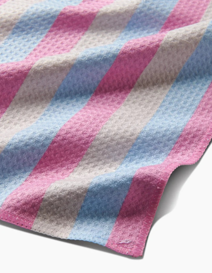Candy Pastels by Amy Droubay features ultra-absorbent, textured Geoweave fabric with pink, blue, and white stripes—softly draped and lightly wrinkled—casting gentle shadows on a white surface; perfect as a bar towel.