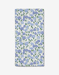 The Carnation Fields Bar Towel by Hufton Studio features a dense blue and purple floral pattern with green leaves on white Geoweave fabric.