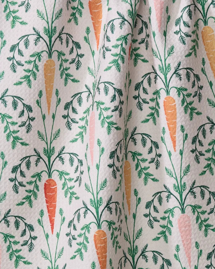 The Carrot Damask kitchen towel by Sarah Daugherty features illustrated orange and pink carrots with green leaves on an off-white, textured, slightly wrinkled fabric—an eco-friendly and charming recycled tea towel.