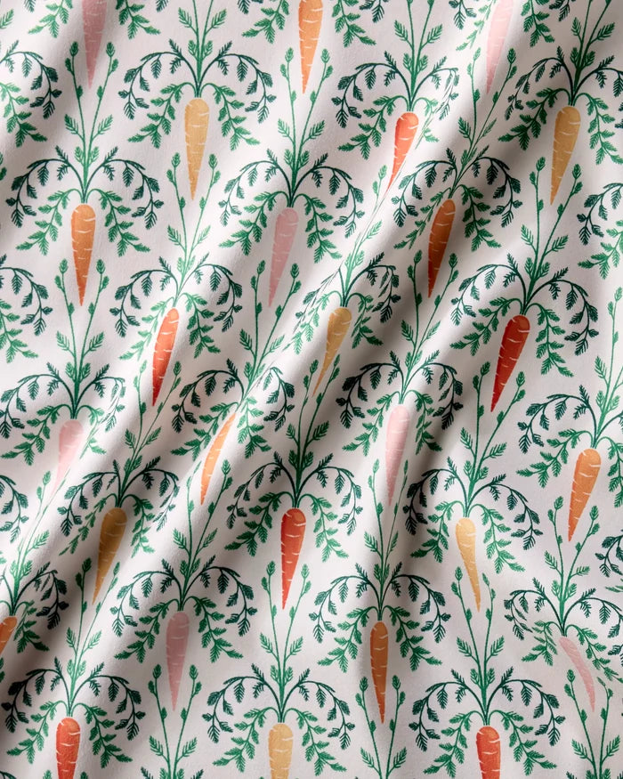 Carrot Damask by Sarah Daugherty features repeating carrot illustrations with leafy tops on white Geosuede. The subtly wrinkled texture adds depth, perfect for recycled or stylish dinner napkin sets.