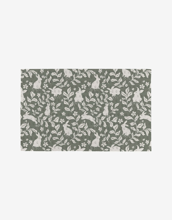 Carrot Patch by Charlie Rowan Designs is a reusable rectangular mat with a green background and a white rabbit, leaf, and flower pattern—an eco-friendly alternative to Not Paper Towels.