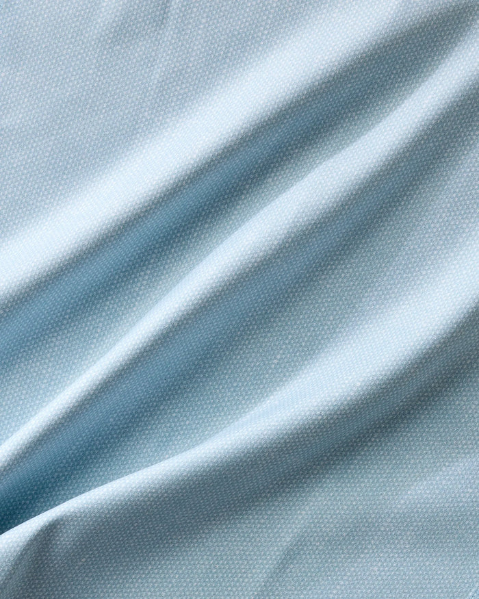 Chambray Light Blue by Geometry: light blue fabric with a subtle dotted texture, draped in gentle folds and soft shadows—ideal for eco-friendly napkins or a stylish recycled dinner napkin set.