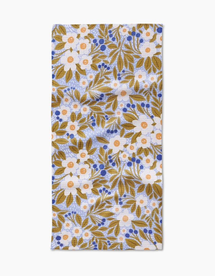 The Lisa Nelson Chamomile And Blue bar towel features a floral print with mustard yellow leaves, white flowers with orange centers, and blue berries on white Geoweave fabric for superior absorbency.