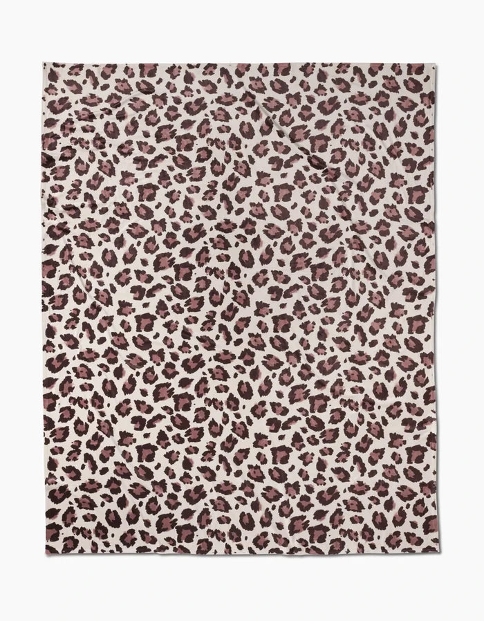 A silky-soft rectangular Geometry Butter Blanket sheet named Cheetah, featuring a cheetah print with dark brown and black spots on a light beige background and a slightly wrinkled appearance.