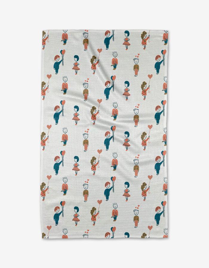The Cheri kitchen towel by Amy MacCready features cartoon girls with hearts and potted plants in blue, red, and brown accents on textured white fabric—a cheerful addition to your kitchen décor.